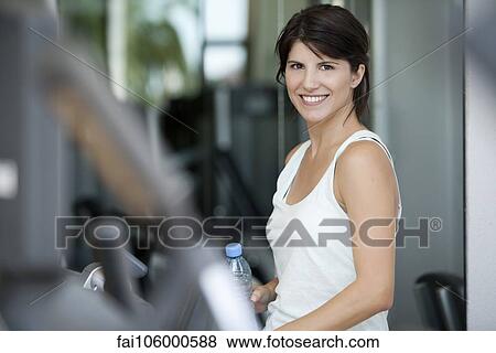 Woman smiling in fitness club, portrait View Large Photo Image Stock Photo - Woman smiling in fitness club, portrait. Fotosearch