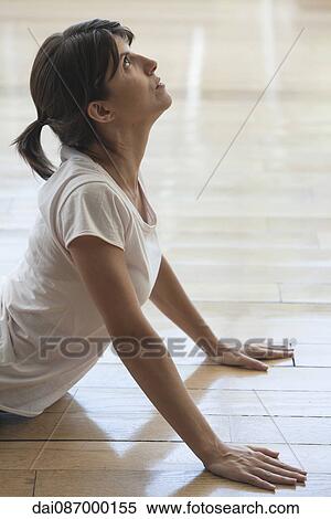 Stock Photography - Woman stretching in cobra pose. Fotosearch