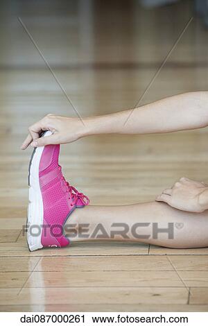 Woman stretching on flloor, cropped View Large Photo Image Stock Image - Woman stretching on flloor, cropped. Fotosearch