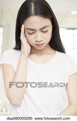 Woman suffering a headache View Large Photo Image Stock Image - Woman suffering a headache. Fotosearch