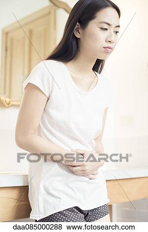 Woman suffering from stomach pain View Large Photo Image Stock Photo - Woman suffering from stomach pain. Fotosearch
