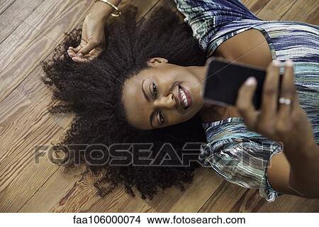 Woman taking selfie with smartphone View Large Photo Image Picture - Woman taking selfie with smartphone. Fotosearch