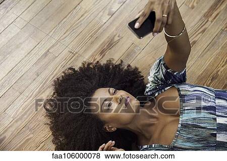 Woman taking selfie with smartphone View Large Photo Image Stock Photo - Woman taking selfie with smartphone. Fotosearch