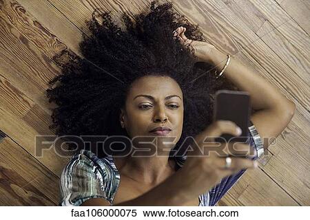 Stock Photography - Woman taking selfie with smartphone. Fotosearch