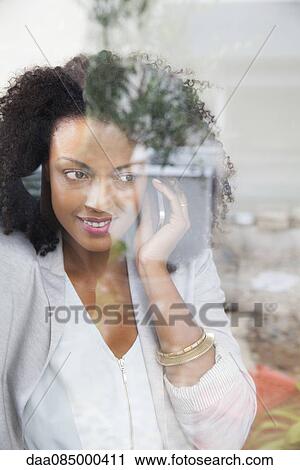 Stock Image - Woman talking on cell phone. Fotosearch