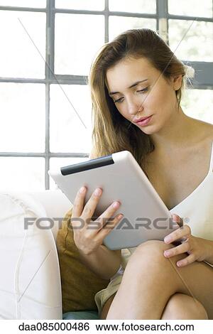 Woman using digital tablet View Large Photo Image Stock Photograph - Woman using digital tablet. Fotosearch