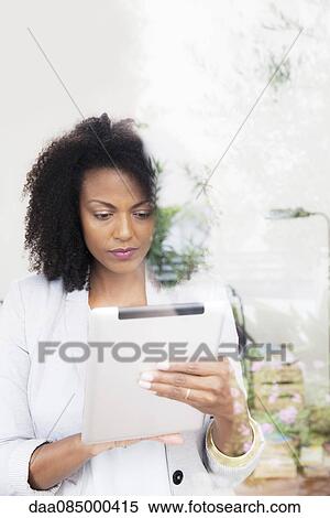 Woman using digital tablet View Large Photo Image Stock Photography - Woman using digital tablet. Fotosearch