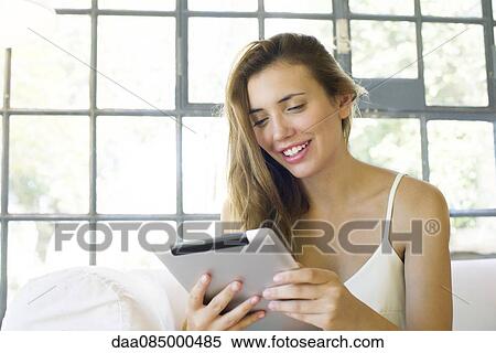 Woman using digital tablet View Large Photo Image Stock Photography - Woman using digital tablet. Fotosearch