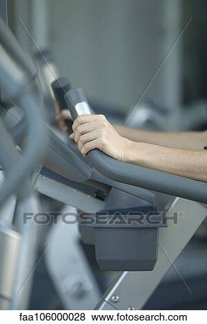 Woman using exercise machine in fitness club, cropped View Large Photo Image Stock Photo - Woman using exercise machine in fitness club, cropped. Fotosearch