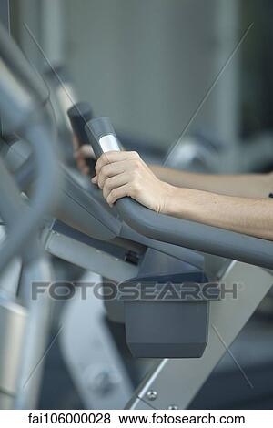 Woman using exercise machine in fitness club, cropped View Large Photo Image Stock Photo - Woman using exercise machine in fitness club, cropped. Fotosearch
