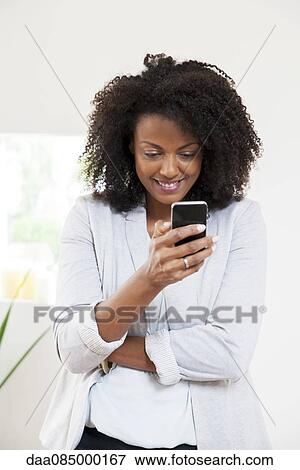 Woman using smartphone View Large Photo Image Stock Photo - Woman using smartphone. Fotosearch