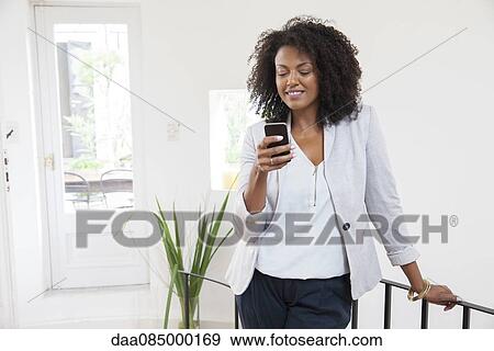 Stock Photo - Woman using smartphone. Fotosearch
