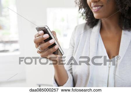 Woman using smartphone View Large Photo Image Stock Photo - Woman using smartphone. Fotosearch