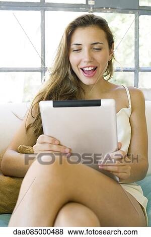 Woman video chatting using digital tablet View Large Photo Image Stock Photo - Woman video chatting using digital tablet. Fotosearch