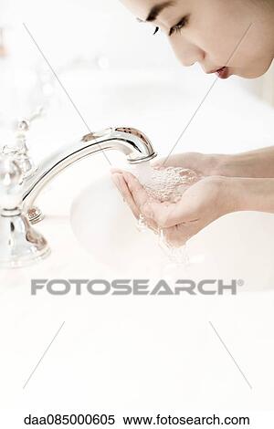 Woman washing her face View Large Photo Image Stock Photography - Woman washing her face. Fotosearch