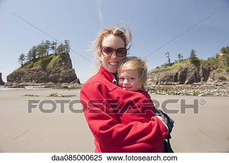 Stock Photography - Woman with young child at beach. Fotosearch
