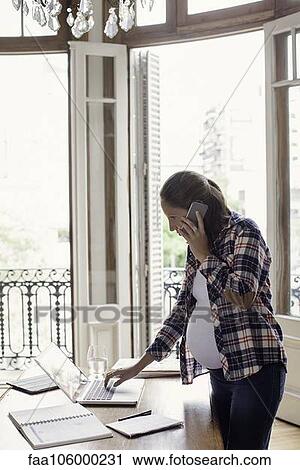 Stock Image - Woman working from home. Fotosearch