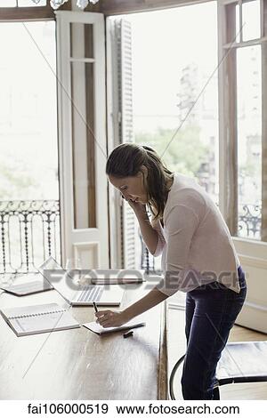 Woman working from home View Large Photo Image Stock Photo - Woman working from home. Fotosearch