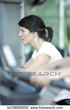 Woman working out in fitness club View Large Photo Image Stock Image - Woman working out in fitness club. Fotosearch