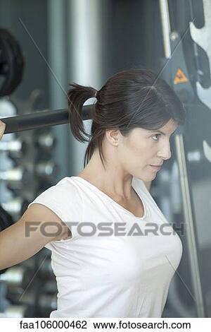 Woman working out in gym View Large Photo Image Stock Image - Woman working out in gym. Fotosearch