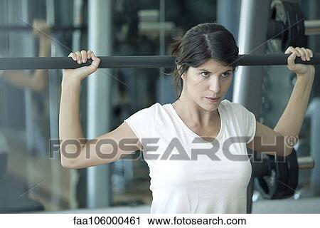 Woman working out in health club View Large Photo Image Stock Image - Woman working out in health club. Fotosearch