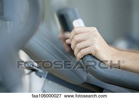 Woman's hands gripping handle of exercise machine, close-up View Large Photo Image Stock Photo - Woman's hands gripping handle of exercise machine, close-up. Fotosearch