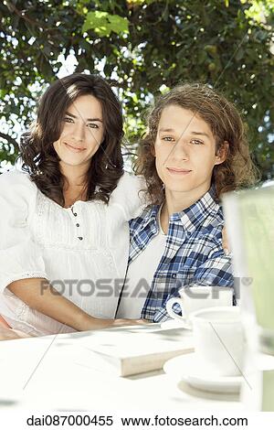 Young couple at breakfast table outdoors View Large Photo Image Stock Photography - Young couple at breakfast table outdoors. Fotosearch