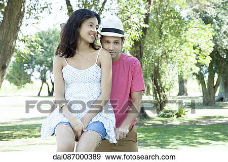 Young couple, boyfriend walking bicycle with girlfriend seated across handlebars View Large Photo Image Stock Photo - Young couple, boyfriend walking bicycle with girlfriend seated across handlebars. Fotosearch