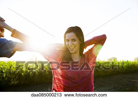 Stock Image - Young couple dancing outdoors. Fotosearch