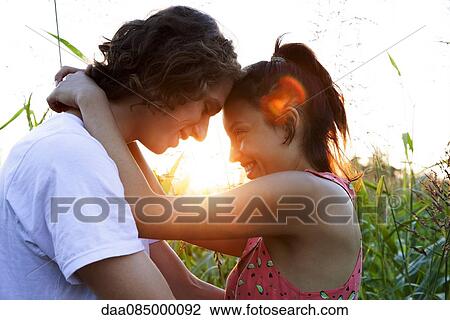 Young couple embracing, touching foreheads View Large Photo Image Stock Image - Young couple embracing, touching foreheads. Fotosearch