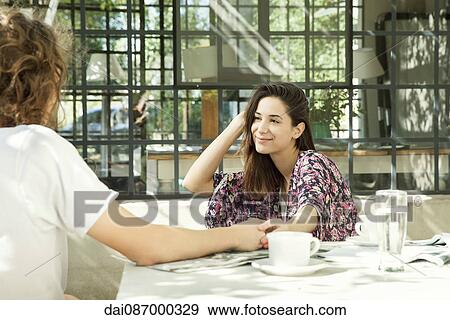 Young couple enjoying breakfast outdoors View Large Photo Image Stock Photo - Young couple enjoying breakfast outdoors. Fotosearch