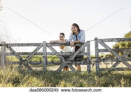 Stock Photography - Young couple hanging out at farm. Fotosearch