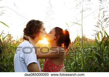 Stock Image - Young couple kissing. Fotosearch