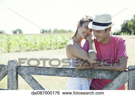 Young couple outdoors, portrait View Large Photo Image Stock Photograph - Young couple outdoors, portrait. Fotosearch
