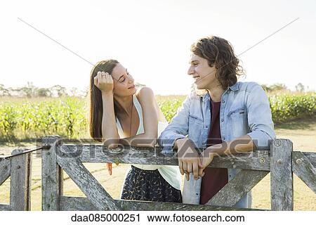 Young couple spending time together in countryside View Large Photo Image Stock Image - Young couple spending time together in countryside. Fotosearch
