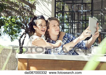 Young couple taking selfie with digital tablet View Large Photo Image Stock Image - Young couple taking selfie with digital tablet. Fotosearch