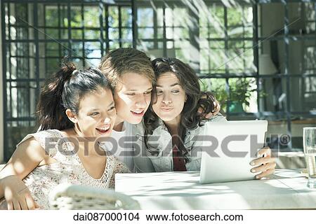 Young friends taking selfie with digital tablet View Large Photo Image Picture - Young friends taking selfie with digital tablet. Fotosearch