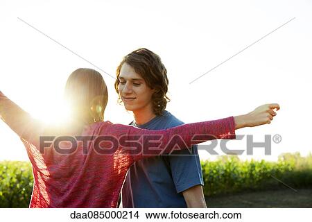 Young woman embracing boyfriend View Large Photo Image Picture - Young woman embracing boyfriend. Fotosearch