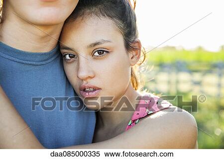 Young woman embracing boyfriend, portrait View Large Photo Image Stock Photography - Young woman embracing boyfriend, portrait. Fotosearch