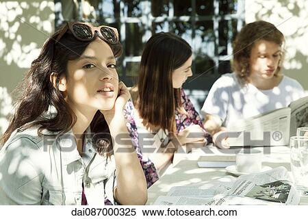 Young woman enjoying meal with friends outdoors View Large Photo Image Stock Photography - Young woman enjoying meal with friends outdoors. Fotosearch