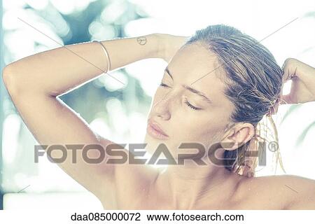 Young woman with hands in hair View Large Photo Image Stock Image - Young woman with hands in hair. Fotosearch