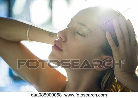 Young woman with hands in hair View Large Photo Image Stock Photo - Young woman with hands in hair. Fotosearch