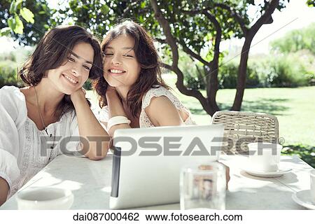 Stock Image - Young women taking selfie with digital tablet. Fotosearch