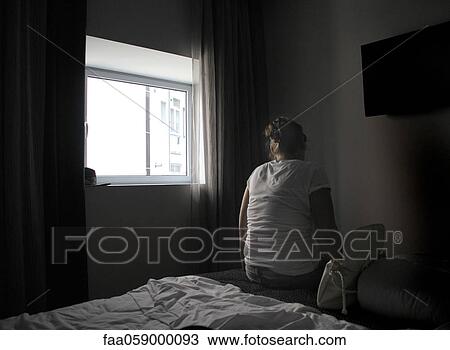 Female sitting alone on bed with back turned to camera View Large Photo Image Stock Image - Female sitting alone on bed with back turned to camera. Fotosearch