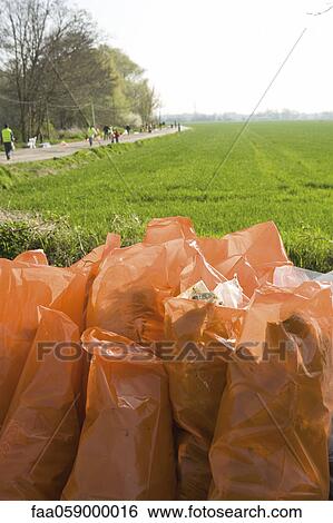 Full bags of trash outdoors, result of cleanup effort View Large Photo Image Stock Photograph - Full bags of trash outdoors, result of cleanup effort. Fotosearch