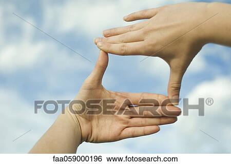Hands making a finger frame in front of sky View Large Photo Image Stock Photograph - Hands making a finger frame in front of sky. Fotosearch
