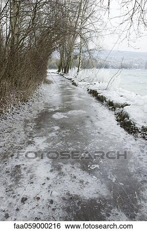Ice-covered path along water's edge View Large Photo Image Stock Photograph - Ice-covered path along water's edge. Fotosearch