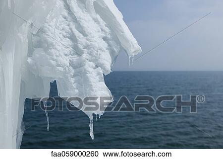 Stock Image - Ice hanging over lake. Fotosearch