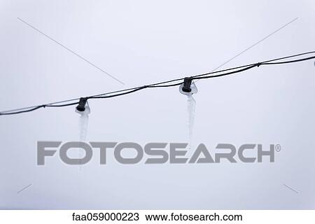 Icicles hanging from power line View Large Photo Image Stock Image - Icicles hanging from power line. Fotosearch