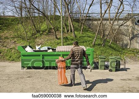 Man taking garbage to dumpster View Large Photo Image Stock Photo - Man taking garbage to dumpster. Fotosearch